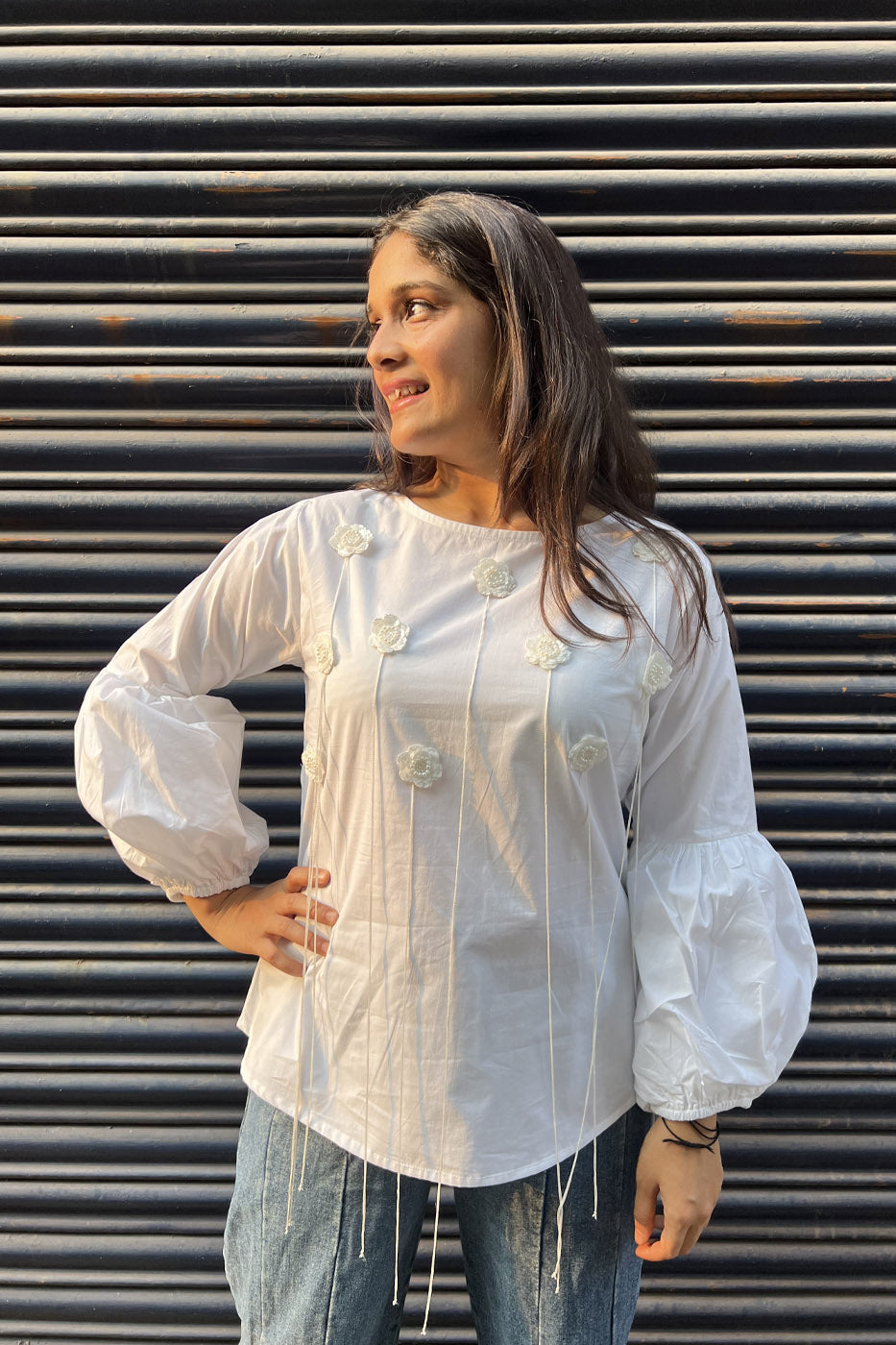 White top with flower and tassel detail