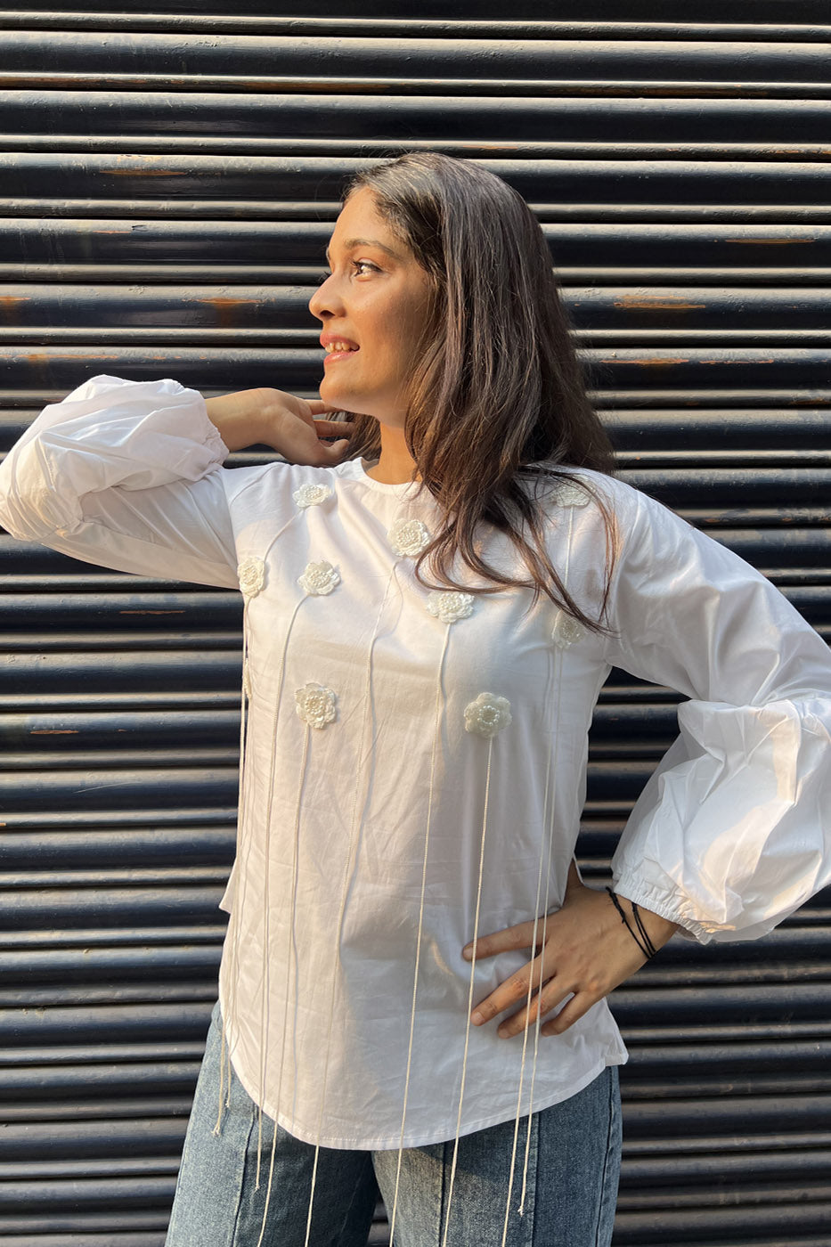 White top with flower and tassel detail