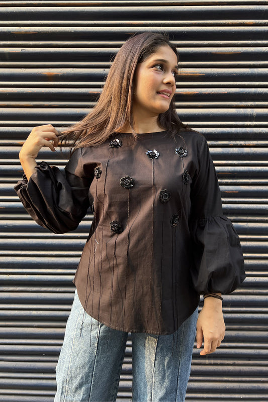 Black top with flower and tassel detail