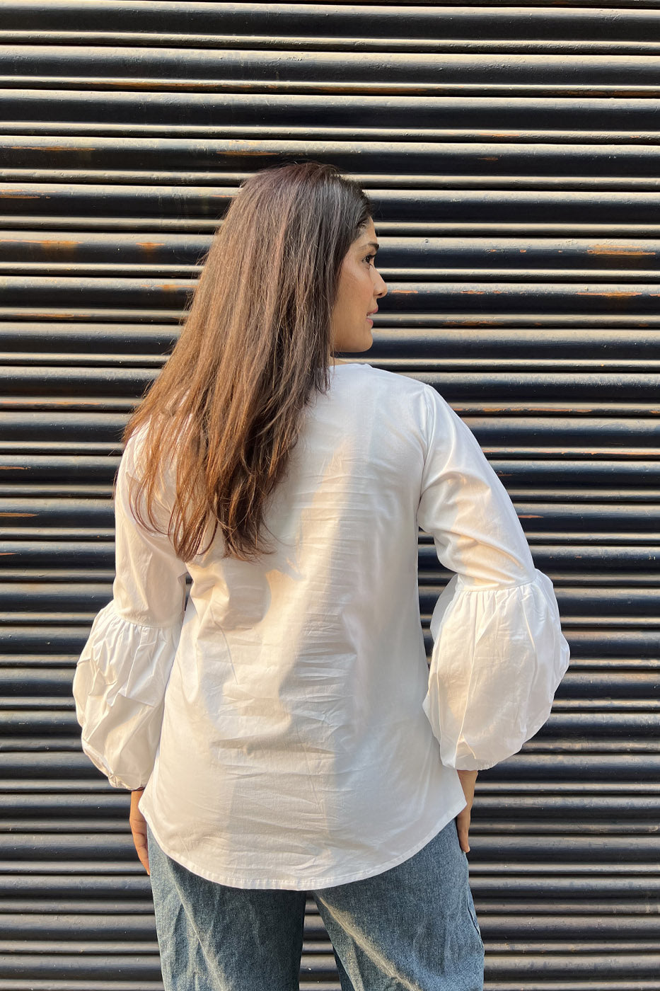 White top with flower and tassel detail