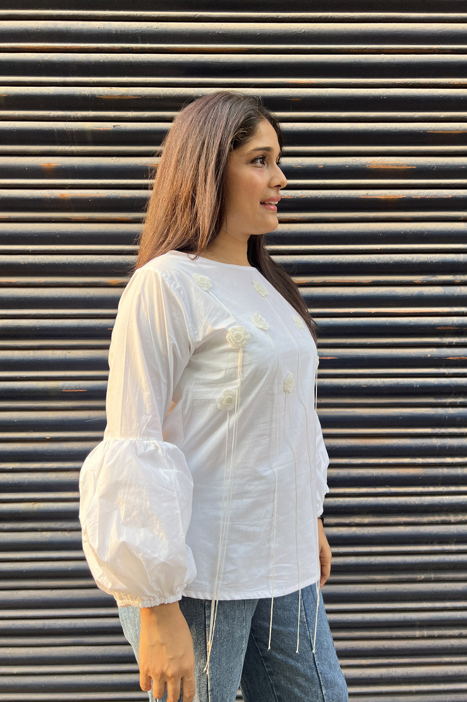 White top with flower and tassel detail