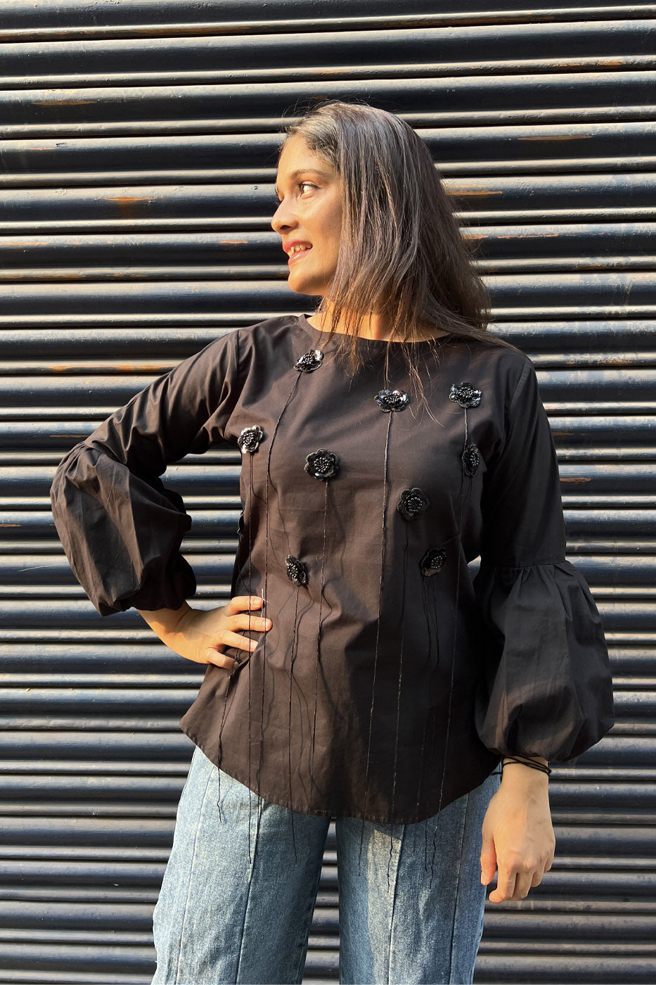 Black top with flower and tassel detail