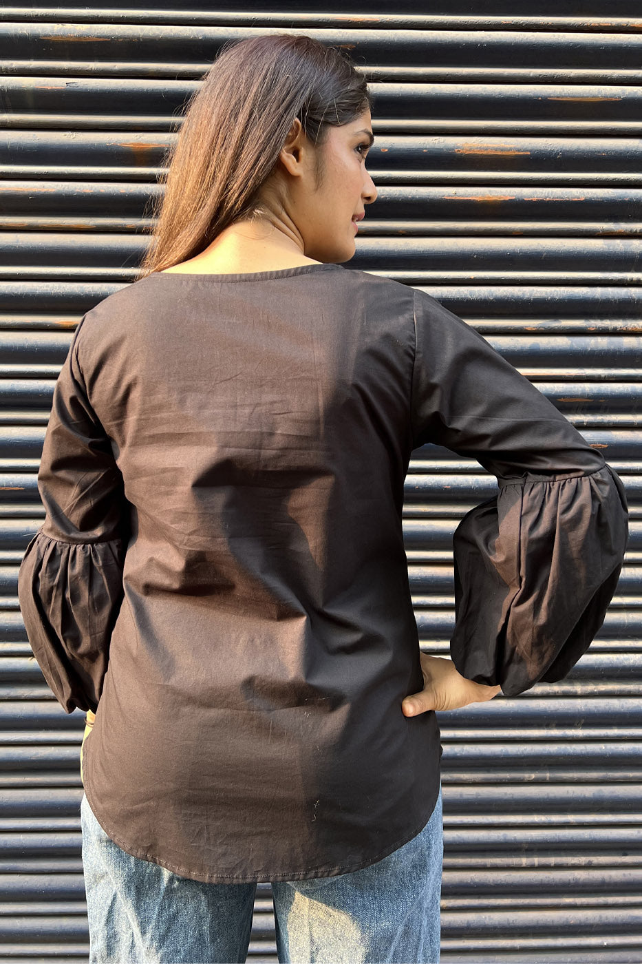 Black top with flower and tassel detail