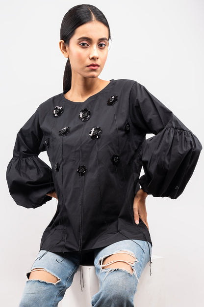 Black top with flower and tassel detail