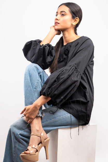 Black top with flower and tassel detail